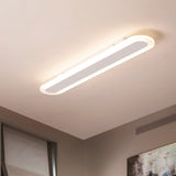 White linear flush mount seen at an angle on a plain ceiling