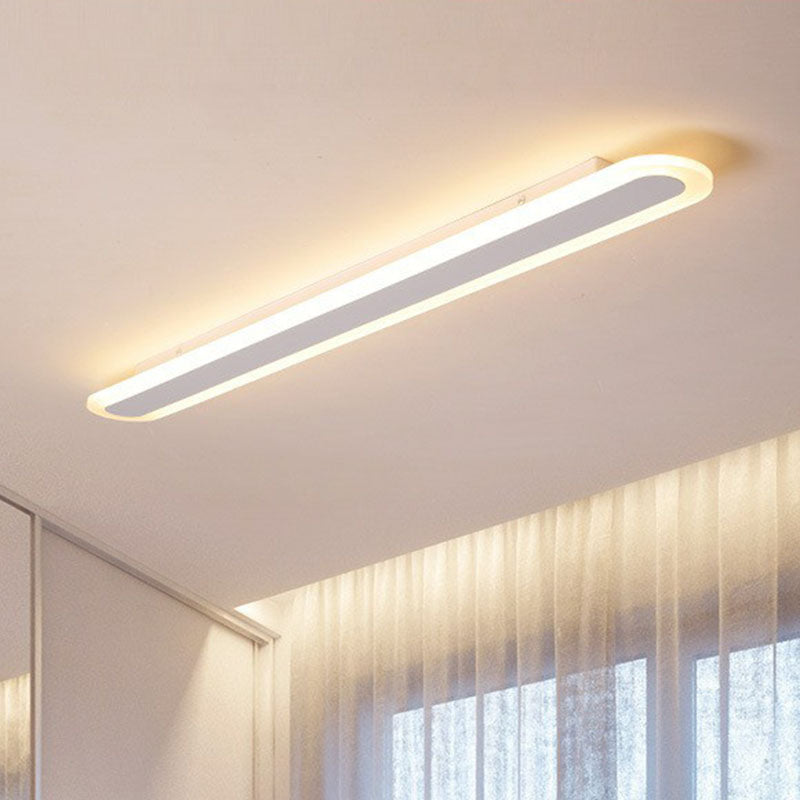 White flush mount fixture above a curtained bedroom window