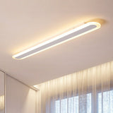 White flush mount fixture above a curtained bedroom window