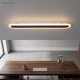 White ceiling light above a walnut desk and keyboard