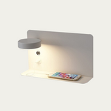 Black wall lamp lit from the front showing warm downlight