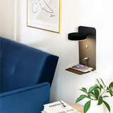 Side view of black wall lamp showing round head and shelf