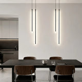 LED linear pendant light suspended above a dining table