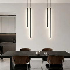 LED linear pendant light suspended above a dining table