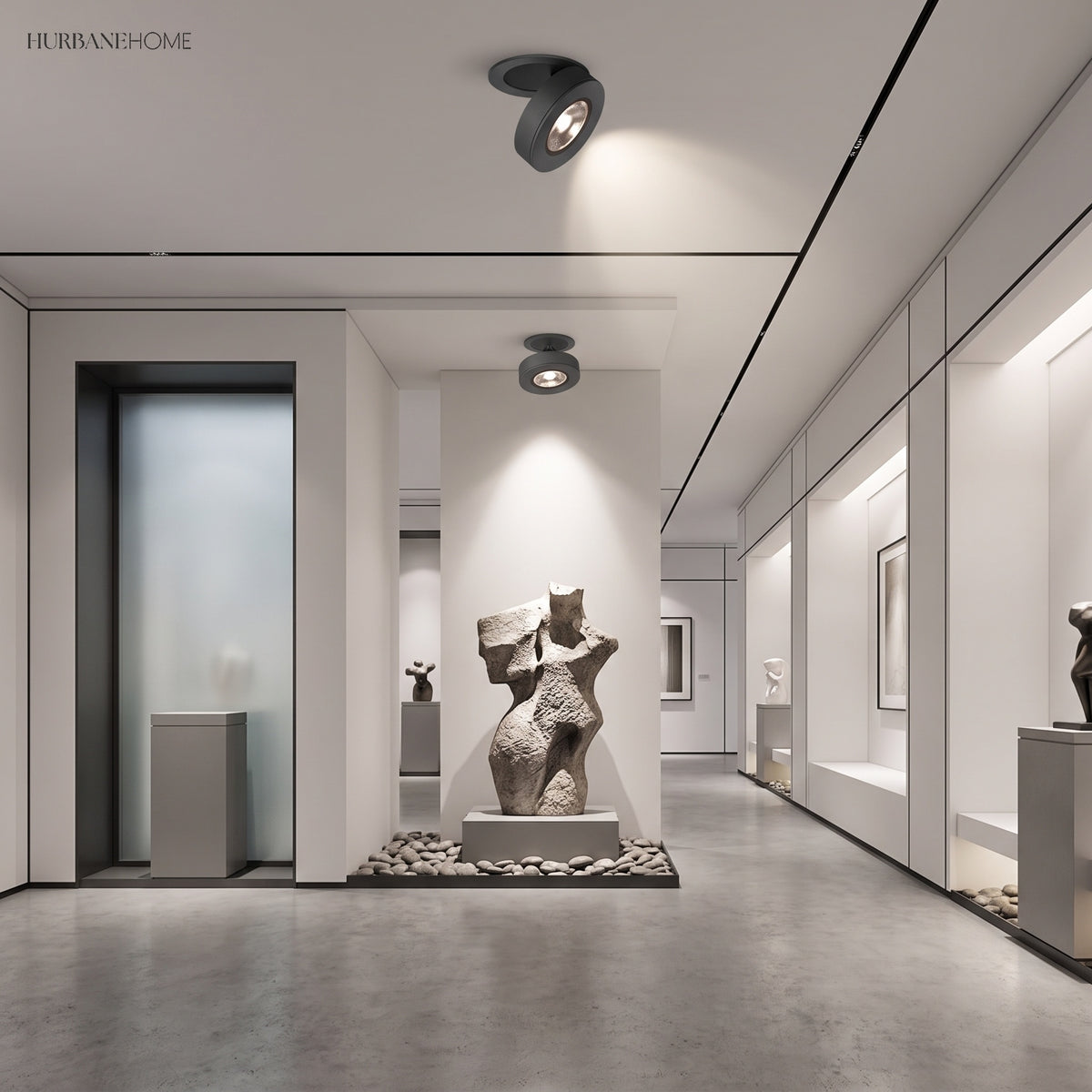 Black spotlight on a gallery ceiling lighting sculptures along a corridor