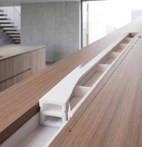 White silicone LED strip profile fitted into a groove under a counter