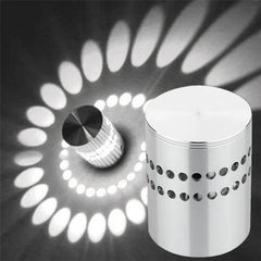 Spiral pattern beside the small aluminium cylinder that projects it