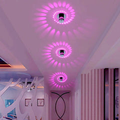 Spiral lights casting pink patterns on a ceiling in a pink room