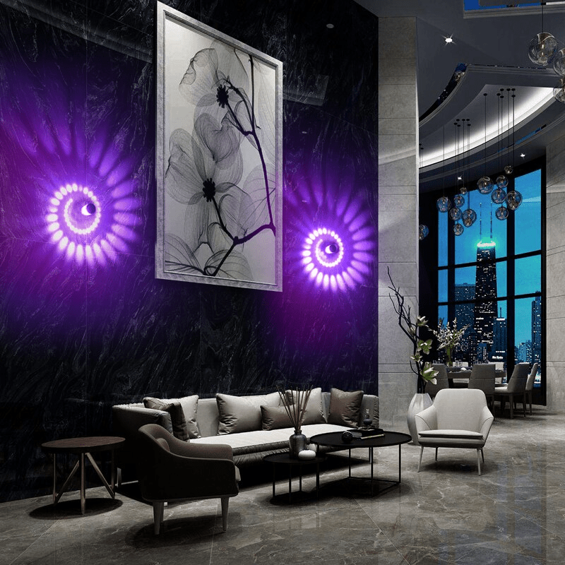 Two spiral wall lights casting purple patterns beside framed artwork