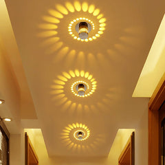 Three spiral effect lights casting warm swirl patterns on a ceiling