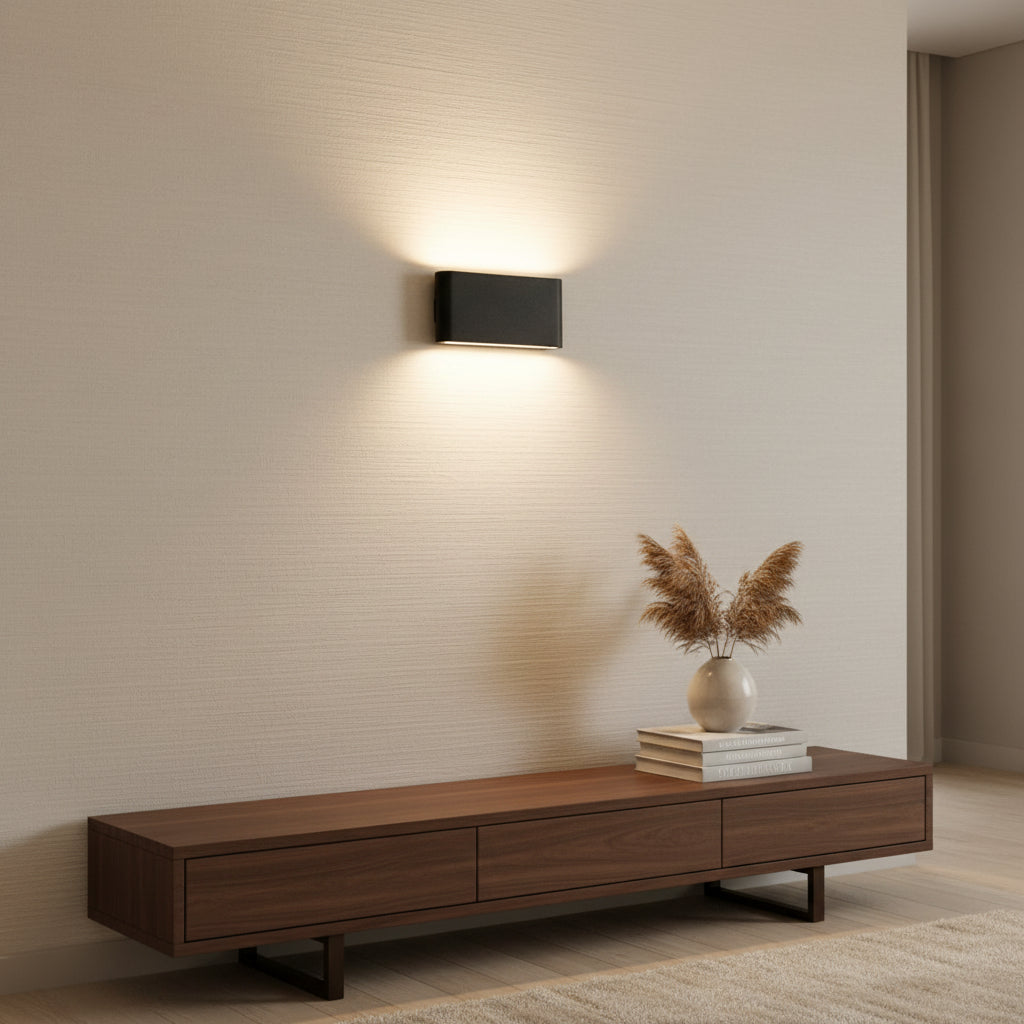 Angled studio view of the black rectangular aluminum wall sconce
