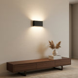 Angled studio view of the black rectangular aluminum wall sconce