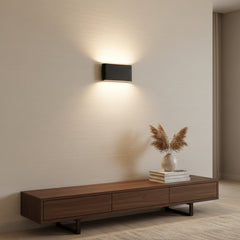 Angled studio view of the black rectangular aluminum wall sconce