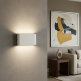 Three quarter studio view of the white aluminum wall sconce