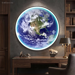 Illuminated Earth globe sconce glowing on a deep blue study wall