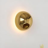 Silver dome sconce lit high on a white wall near a ceiling
