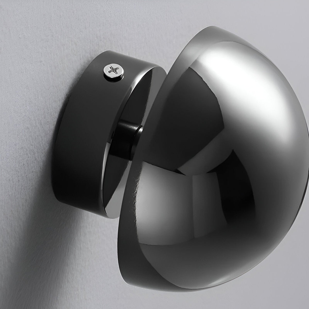 Mirrored dome sconces seen from behind showing the mounting plate