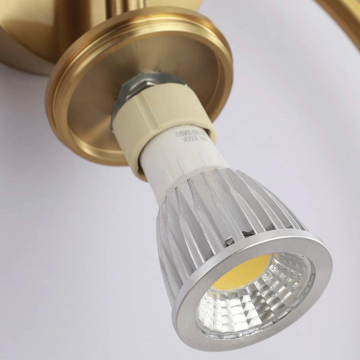 Close view of the GU10 LED bulb fitted inside the brass spot head