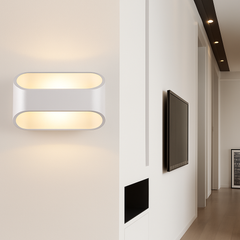 White oval sconce lit in a hallway beside a mounted screen
