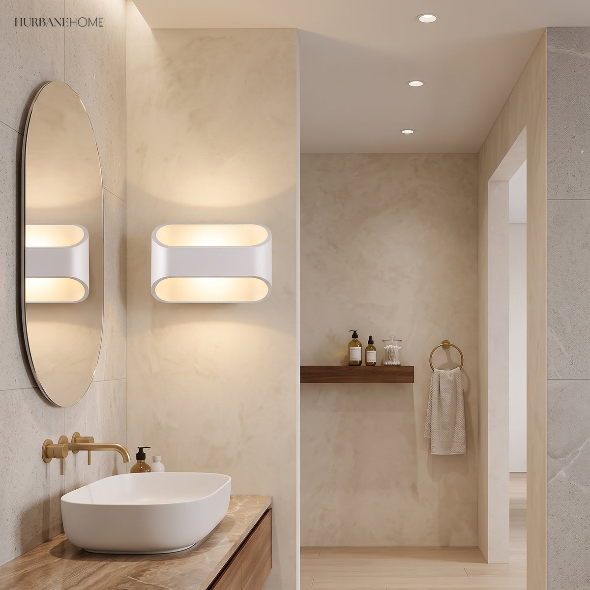 Two white oval sconces lit beside a bathroom mirror and basin