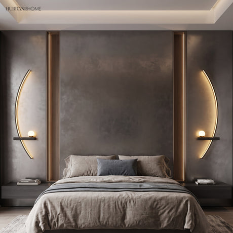 Two black arc wall lights framing a bed in a dark modern bedroom