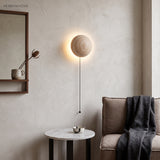 Travertine LED wall sconce beside a mirror and console in a calm styled room