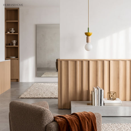 Yellow dome and ash wood pendant light hanging in a bright minimalist room