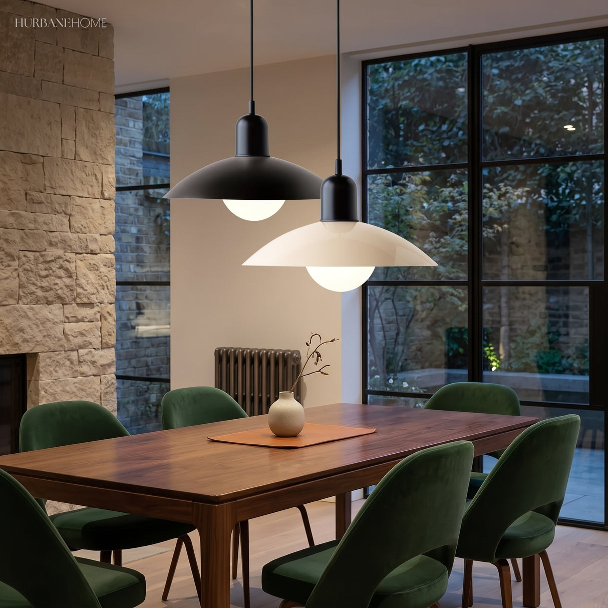 Two dome pendant lights above a walnut dining table with green velvet chairs