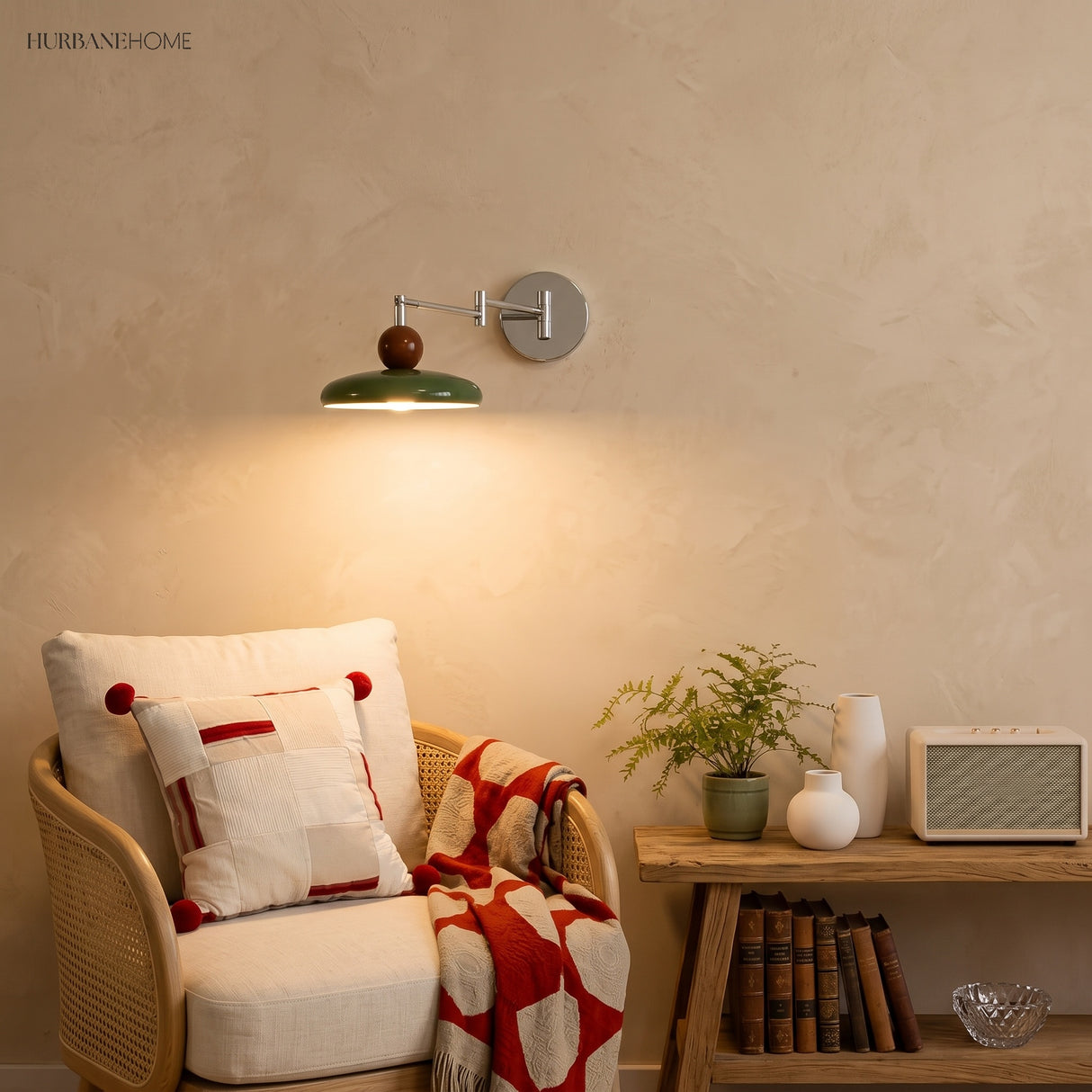 Beige disc swing arm wall lamp glowing warmly above a rattan armchair