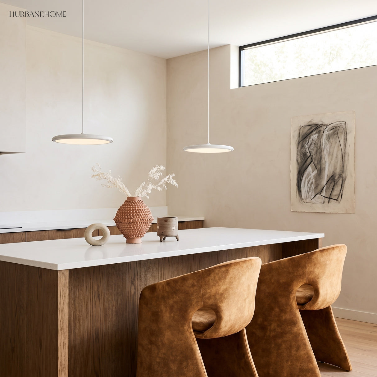 Two white disc pendant lights above a white kitchen island with terracotta bar stools