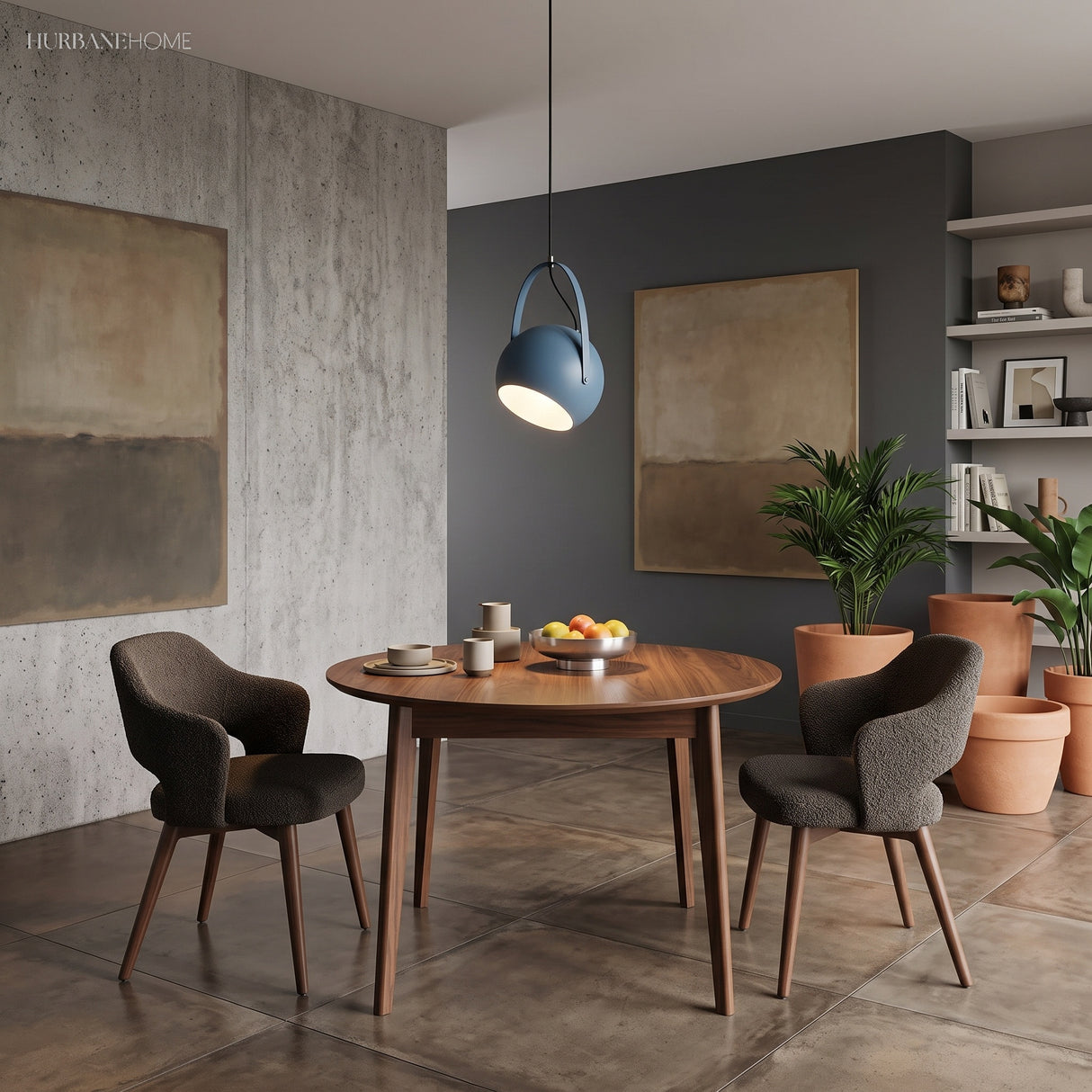 Blue metal pendant light glowing over a round walnut dining table