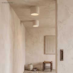 Pair of cream flush mount ceiling lights in a minimalist plaster corridor