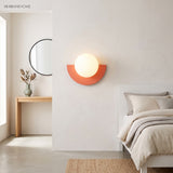 Terracotta half moon wall sconce in a bright minimalist bedroom