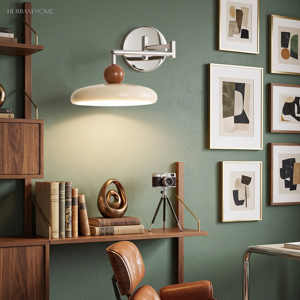 Cream swing arm wall sconce on green wall beside framed abstract art