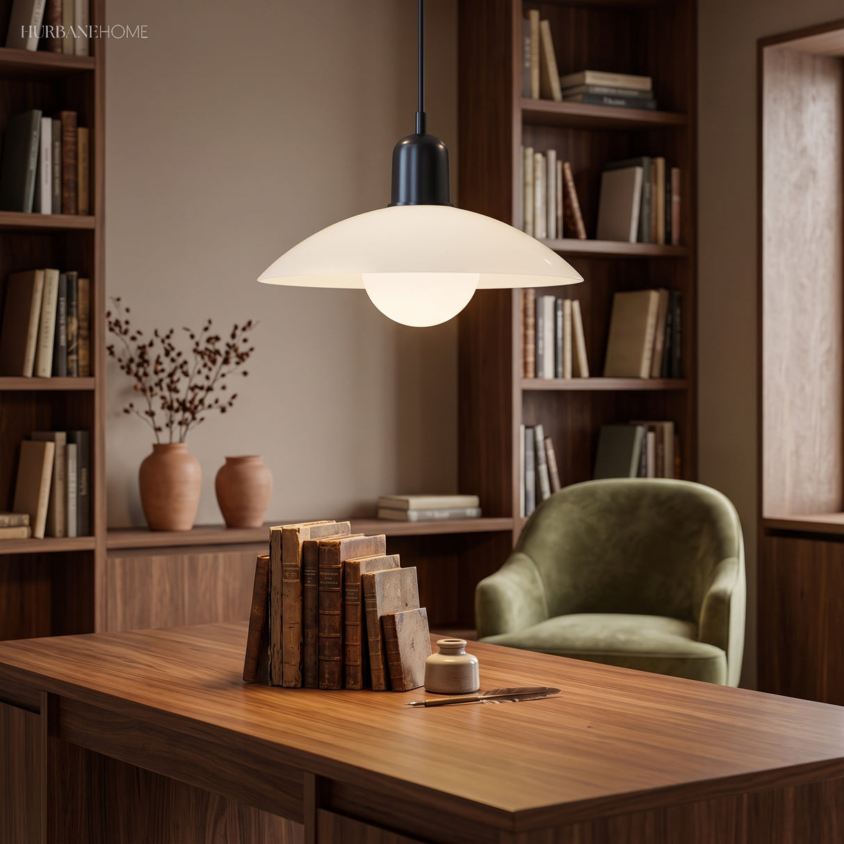 White glass globe pendant light lit over a wood desk in a study