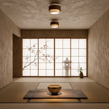 Two travertine ceiling lights lighting a minimalist tatami room with shoji screens