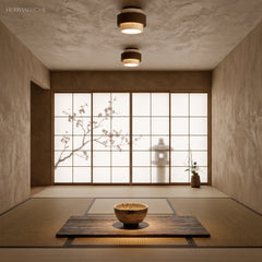 Two travertine ceiling lights lighting a minimalist tatami room with shoji screens