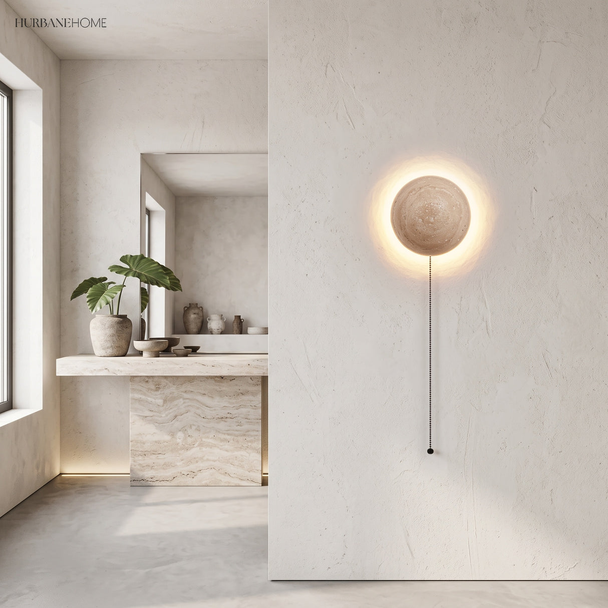 Stone wall sconce with pull-cord glowing in a bright minimalist interior