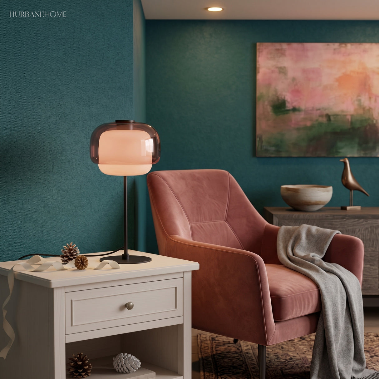 Glowing amber table lamp on a white side table beside a pink armchair