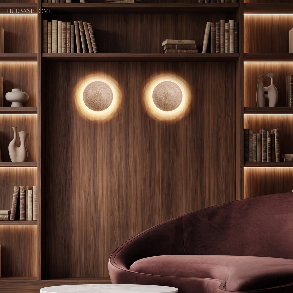 Pair of travertine wall sconces on a warm timber wall above a lounge chair