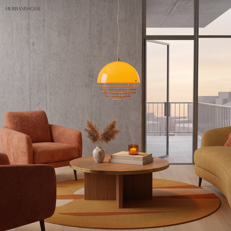 Orange glass dome pendant glowing above a wood coffee table in a warm living room