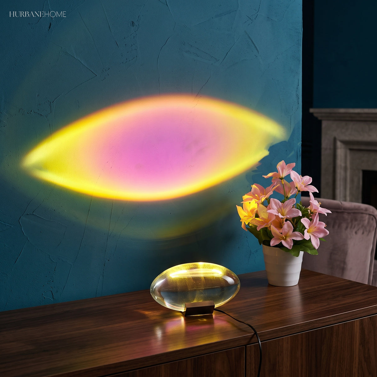 Ambient lamp projecting a pink and gold oval glow on a wall