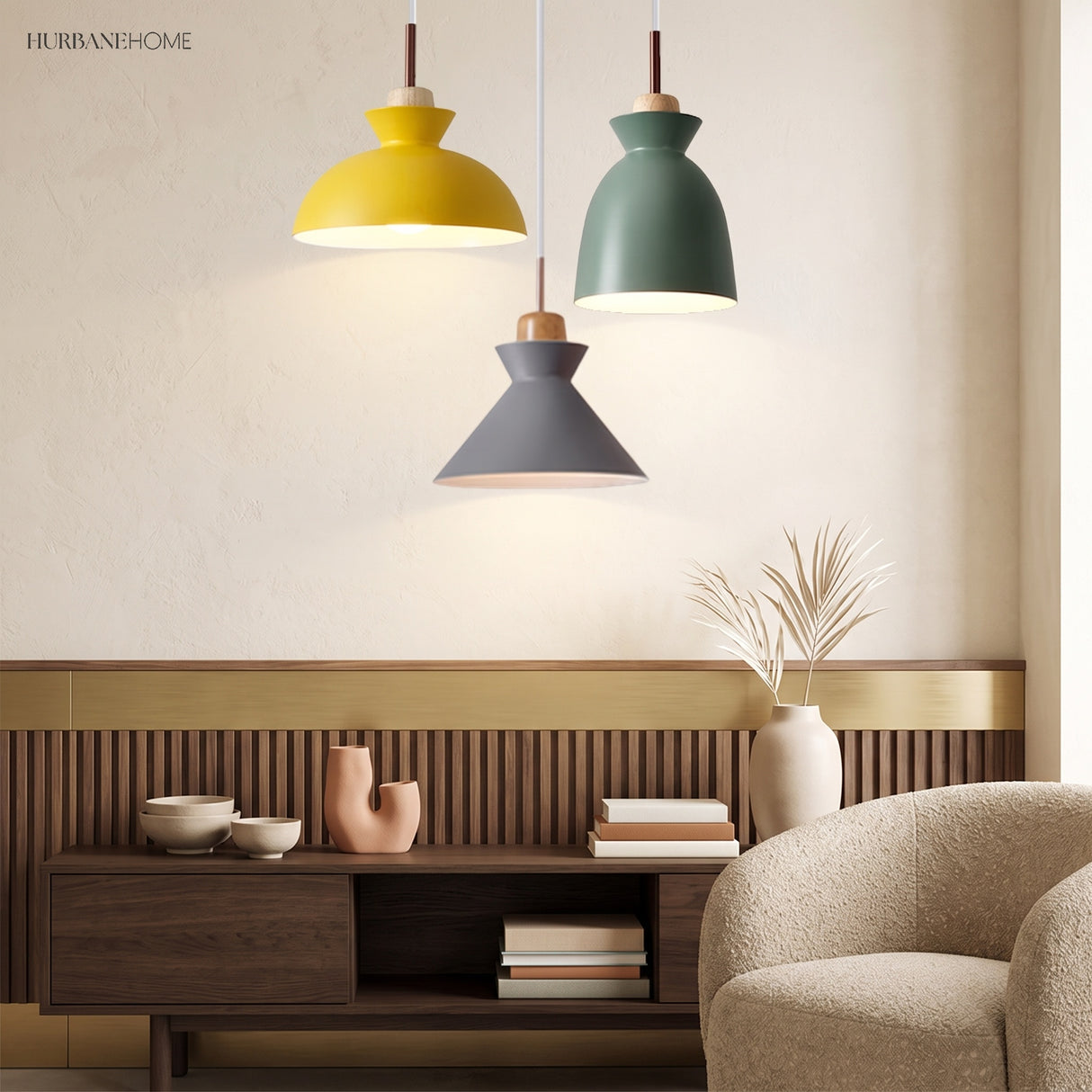 Yellow, green and grey pendant lights grouped above a walnut sideboard and armchair