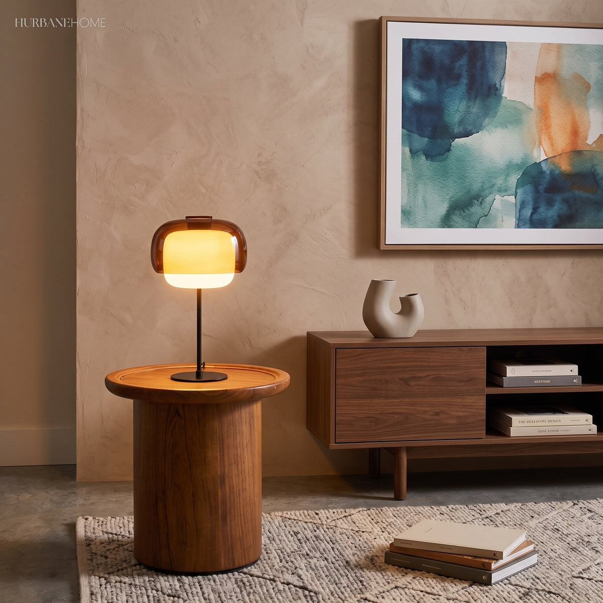 Warm-lit glass table lamp on a round walnut side table in a living room