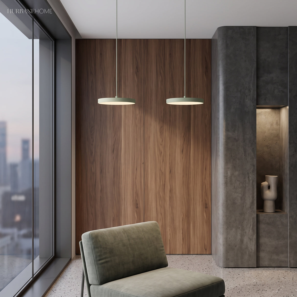 Two sage green disc pendants suspended against a warm walnut panelled wall