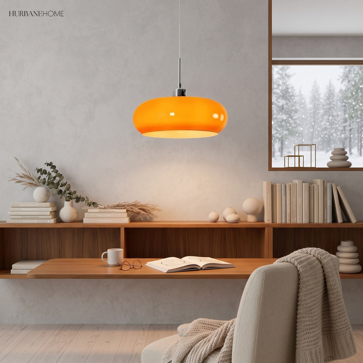 Orange glass pendant light glowing above a wooden reading shelf in a study
