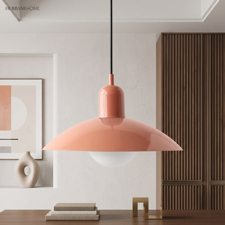Coral pink dome pendant light above a console with framed wall art