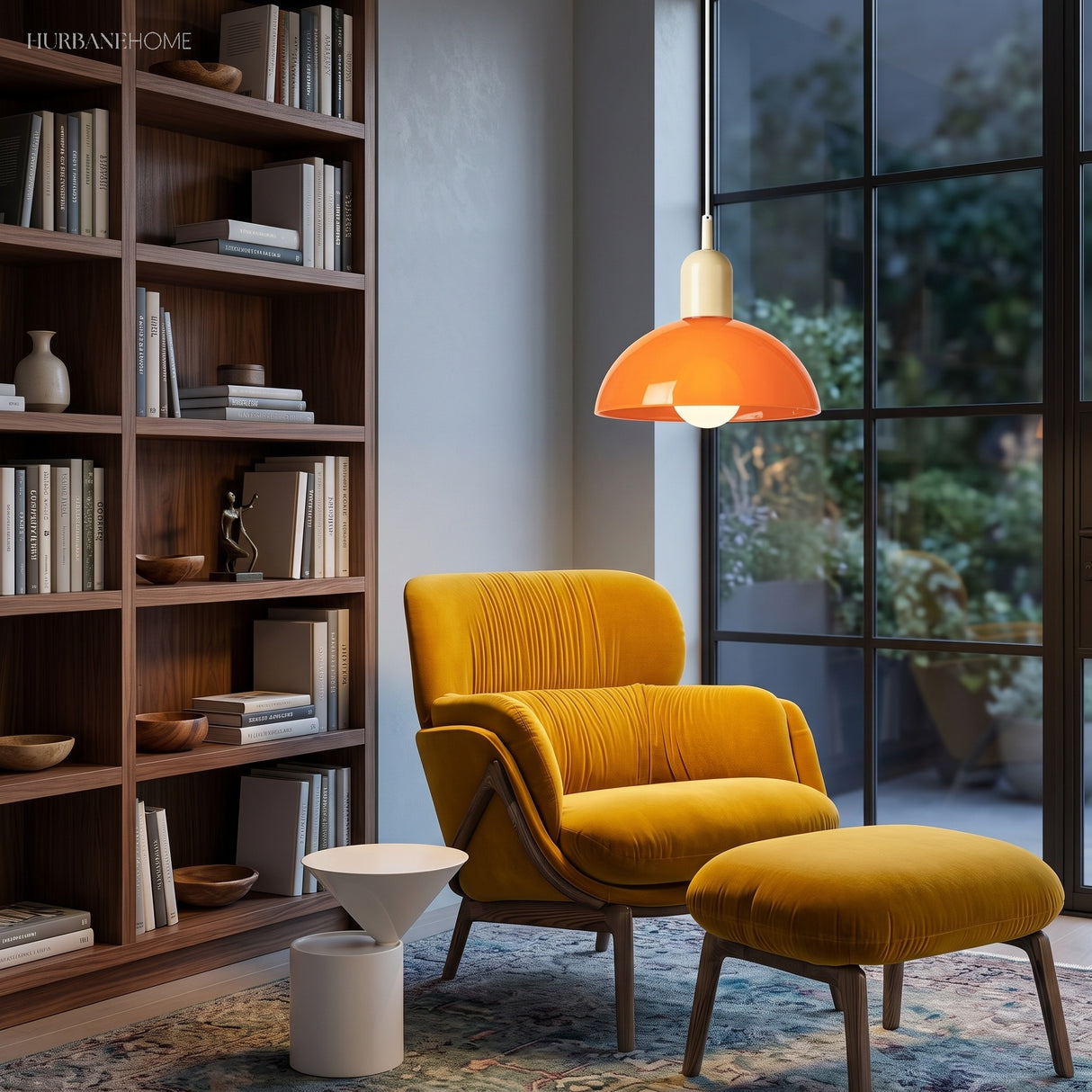 Orange bowl pendant light glowing above a mustard reading chair and shelves