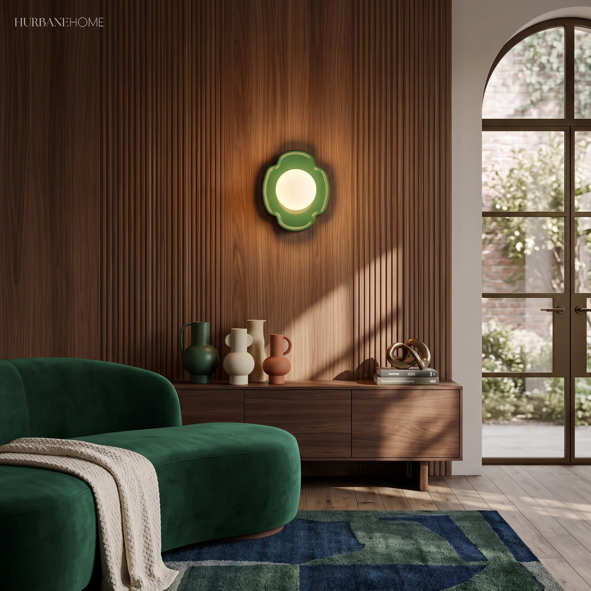 Green orb wall sconce on walnut panelling above a wooden sideboard