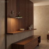Green disc wall sconce lighting a wood-slat feature wall at night